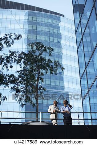 Two Businesspeople Looking Up on Footbridge View Large Photo Image Stock Photo - Two Businesspeople Looking Up on Footbridge. Fotosearch
