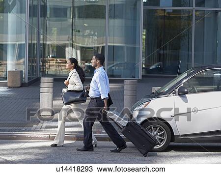 Two Businesspeople Walking with Suitcase View Large Photo Image Stock Image - Two Businesspeople Walking with Suitcase. Fotosearch