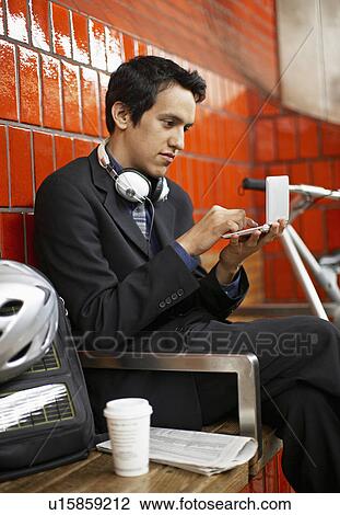 Young Businessman Using PDA at Subway Station View Large Photo Image Stock Image - Young Businessman Using PDA at Subway Station. Fotosearch