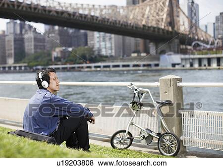 Young Man Listening to Headphones View Large Photo Image Stock Photo - Young Man Listening to Headphones . Fotosearch
