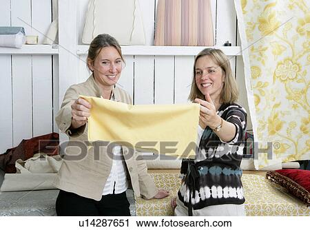 2 women choosing fabric View Large Photo Image Stock Image - 2 women choosing fabric. Fotosearch