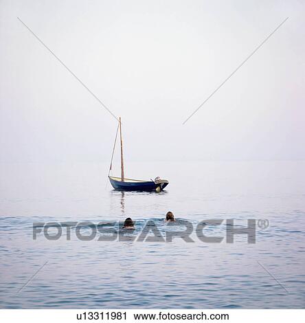 2 women swimming to boat View Large Photo Image Stock Image - 2 women swimming to boat. Fotosearch
