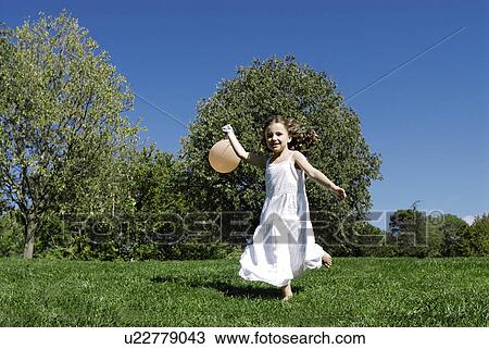 5 years old girl holding a balloon View Large Photo Image Stock Image - 5 years old girl holding a balloon. Fotosearch