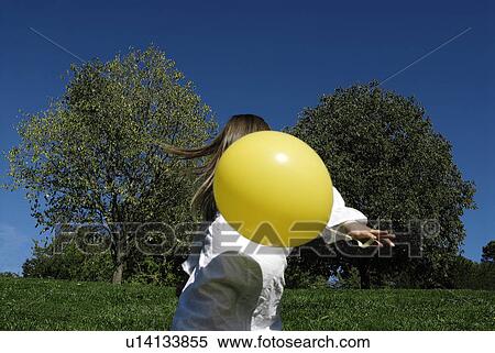 5 years old girl holding a balloon View Large Photo Image Stock Photography - 5 years old girl holding a balloon. Fotosearch