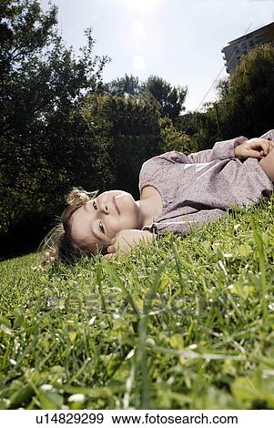 Stock Photo - 5 years old girl in the grass. Fotosearch