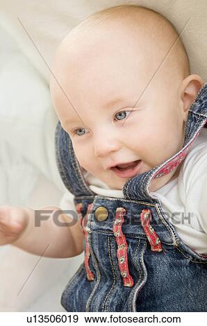 Stock Photo - A baby relaxed and smiling.. Fotosearch
