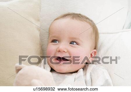 A baby smiling holding a bear View Large Photo Image Stock Image - A baby smiling holding a bear. Fotosearch