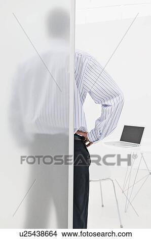 Picture - A business man looking at his laptop. Fotosearch