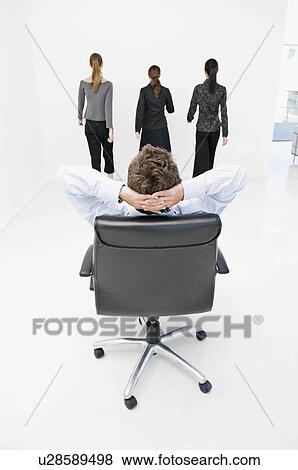 A business man reclining in chair. View Large Photo Image Stock Photo - A business man reclining in chair.. Fotosearch
