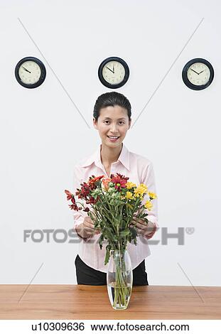 A business woman arranging flowers View Large Photo Image Stock Photograph - A business woman arranging flowers. Fotosearch