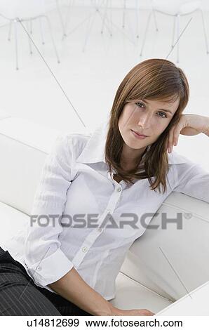 A business woman sat on a sofa View Large Photo Image Stock Photo - A business woman sat on a sofa. Fotosearch