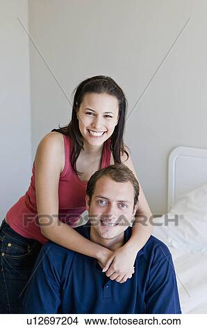 Picture - A couple in their bedroom.. Fotosearch