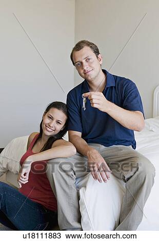 Stock Image - A couple in their bedroom.. Fotosearch