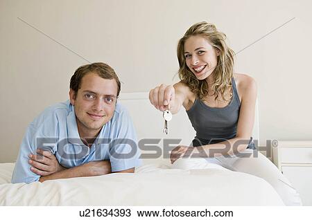 A couple in their bedroom. View Large Photo Image Stock Image - A couple in their bedroom.. Fotosearch