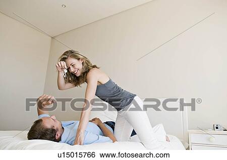 Stock Photograph - A couple in their bedroom.. Fotosearch