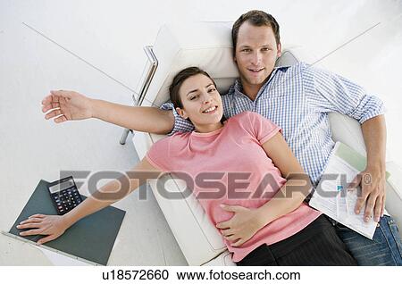 A couple lying on sofa View Large Photo Image Stock Image - A couple lying on sofa. Fotosearch
