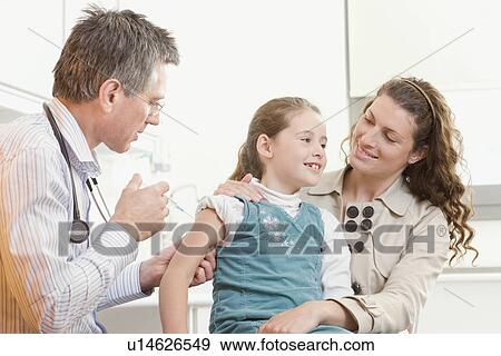 A doctor gives a girl an injection View Large Photo Image Stock Photo - A doctor gives a girl an injection. Fotosearch