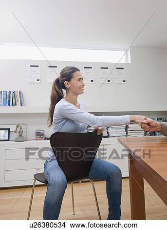 Picture - A female business woman shaking hands.. Fotosearch