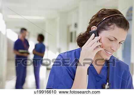A female doctor on the phone View Large Photo Image Stock Image - A female doctor on the phone. Fotosearch