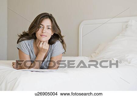Picture - A female in her bedroom.. Fotosearch