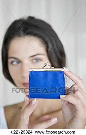 Picture - A female looking at a purse.. Fotosearch