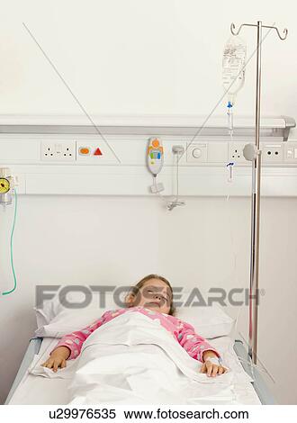 Stock Photography - A little girl in a hospital bed. Fotosearch