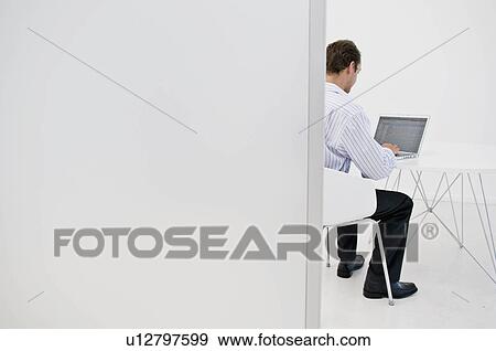 A man on his laptop View Large Photo Image Stock Photo - A man on his laptop. Fotosearch