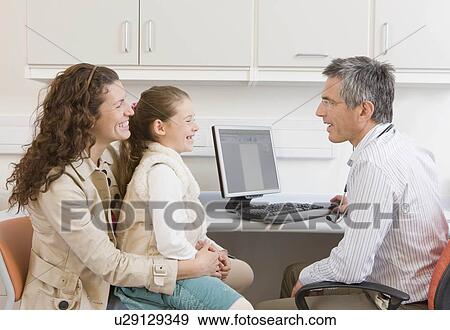 Stock Photo - A mother and daughter visit the doctor. Fotosearch