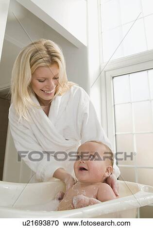 A mother bathing her baby boy View Large Photo Image Stock Image - A mother bathing her baby boy. Fotosearch