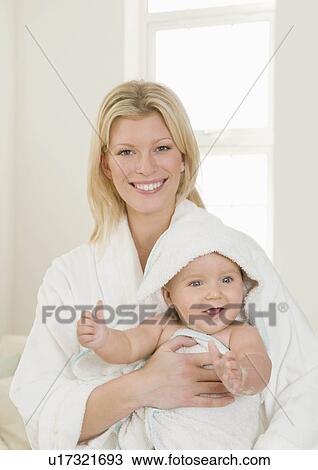 A mother holding her baby in a towel View Large Photo Image Stock Image - A mother holding her baby in a towel. Fotosearch