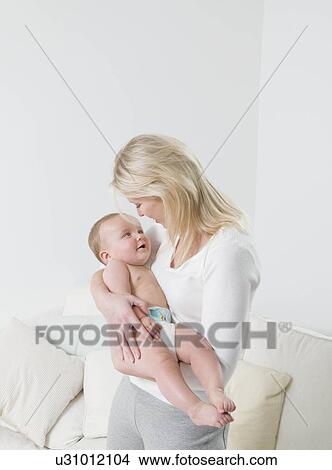 A mother holding her child. View Large Photo Image Picture - A mother holding her child.. Fotosearch