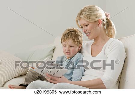 A mother reading to her child View Large Photo Image Stock Photography - A mother reading to her child. Fotosearch