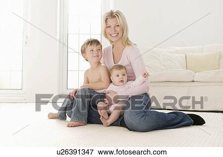 A mother sitting with her two children View Large Photo Image Stock Photo - A mother sitting with her two children. Fotosearch