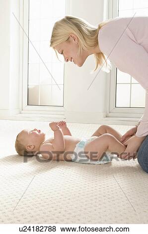 Stock Photo - A mother smiling at her baby. Fotosearch