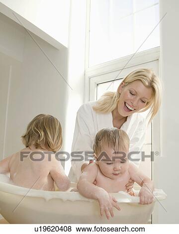 A mum bathing her babies. View Large Photo Image Stock Photo - A mum bathing her babies.. Fotosearch