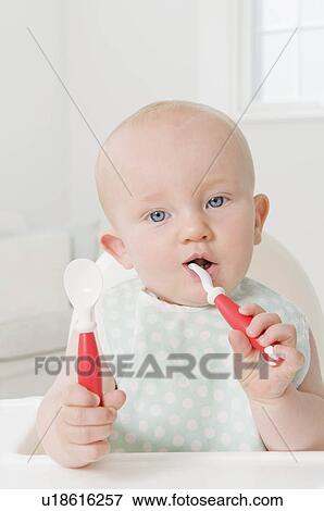 Stock Photo - A portrait of a baby waiting for food. Fotosearch