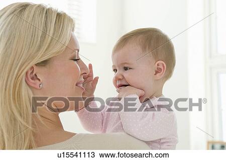 A portrait of a mother and baby girl View Large Photo Image Stock Image - A portrait of a mother and baby girl. Fotosearch