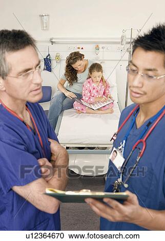 Stock Image - A portrait of two doctors and a patient. Fotosearch