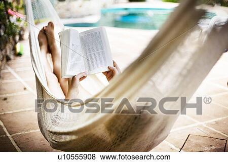 Stock Photo - A woman asleep in a hammock. Fotosearch