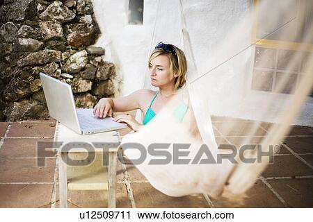 A woman in a hammock View Large Photo Image Stock Image - A woman in a hammock. Fotosearch