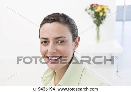 A woman with a vase of flowers View Large Photo Image Picture - A woman with a vase of flowers. Fotosearch