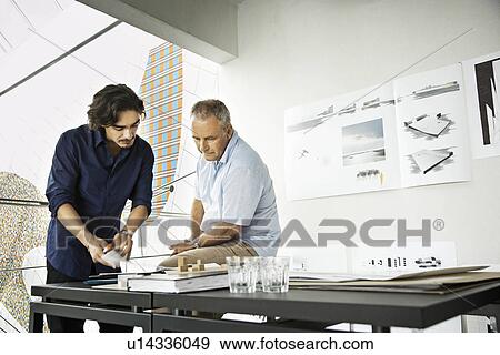 Stock Photo - Architects working on a project. Fotosearch