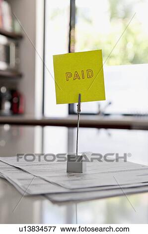 Bills on a paid pile View Large Photo Image Stock Photo - Bills on a paid pile. Fotosearch