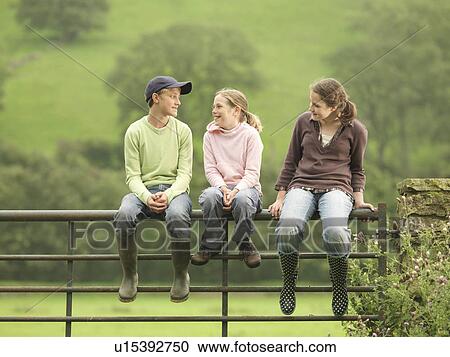 Boy And Girls Sitting On Gate View Large Photo Image Stock Image - Boy And Girls Sitting On Gate. Fotosearch