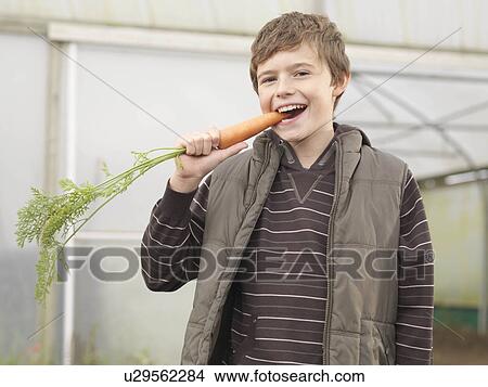 Boy Eating Carrot View Large Photo Image Picture - Boy Eating Carrot. Fotosearch