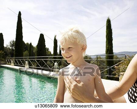 Boy having cream on chest View Large Photo Image Stock Photo - Boy having cream on chest. Fotosearch