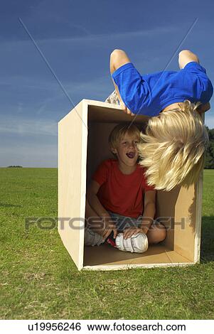 Stock Photograph - boy in box shouting. Fotosearch