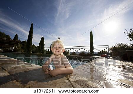 Stock Image - Boy in pool. Fotosearch