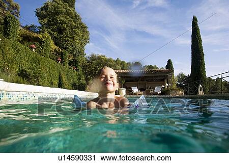 Stock Image - Boy in swimming pool. Fotosearch