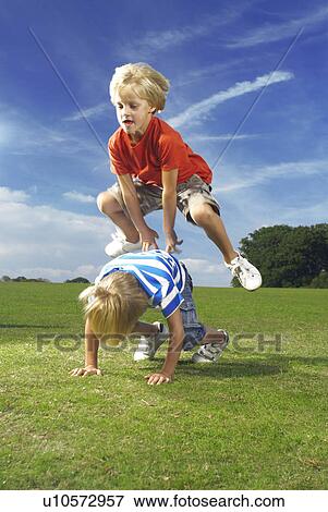 boy leapfrogging View Large Photo Image Stock Photo - boy leapfrogging. Fotosearch